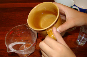 poniendo agua en una taza